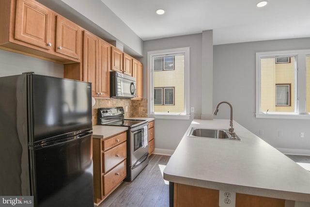 400 Renfro Dr Unit 209, Glen Burnie, MD 21060 - kitchen with black appliances, a sink, a peninsula, recessed lighting, and baseboards