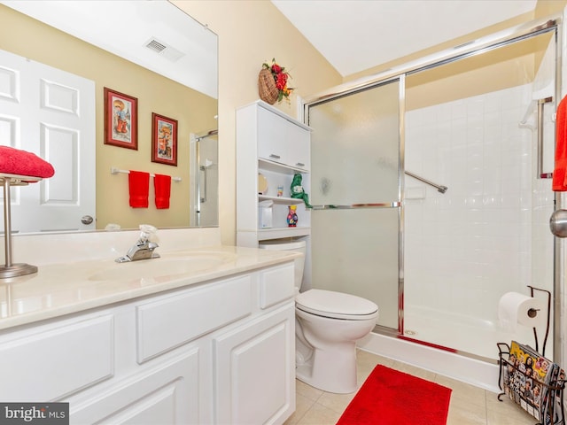 full bath featuring tile patterned flooring, a tile shower, toilet, and vanity