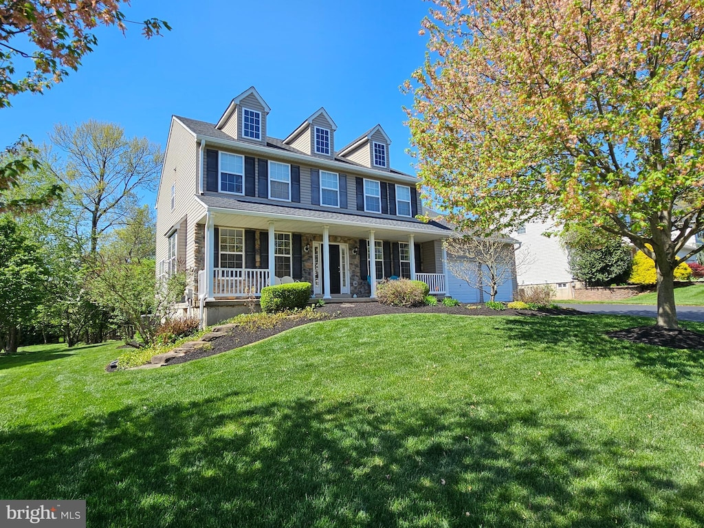 view of front of house with a porch and a front yard