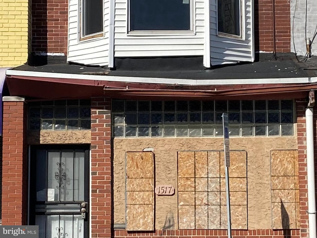 property entrance with brick siding
