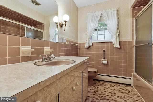 bathroom with visible vents, vanity, tile patterned floors, a baseboard heating unit, and toilet