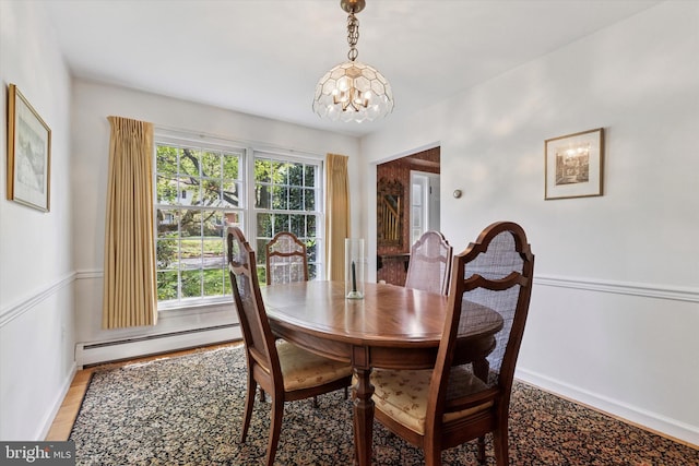 dining room with baseboards, a baseboard heating unit, an inviting chandelier, and light wood-style floors