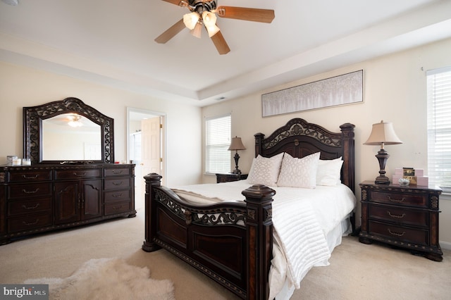 57 Pebble Creek Dr, Smyrna, DE 19977 - bedroom featuring light carpet, multiple windows, ceiling fan, and a raised ceiling