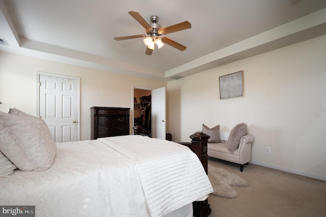 57 Pebble Creek Dr, Smyrna, DE 19977 - carpeted bedroom featuring a spacious closet, a tray ceiling, baseboards, a closet, and a ceiling fan