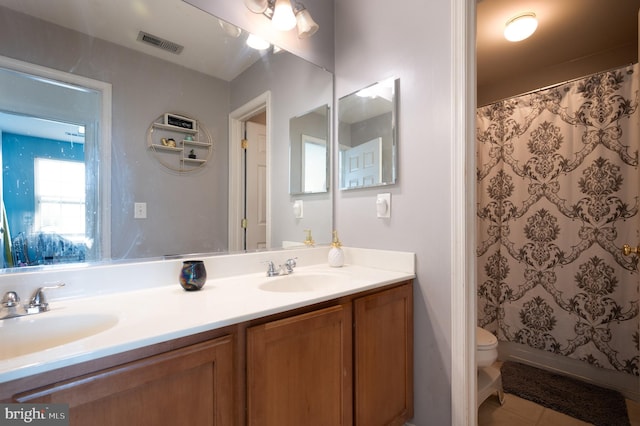 57 Pebble Creek Dr, Smyrna, DE 19977 - full bathroom with double vanity, toilet, a shower with curtain, and tile patterned flooring