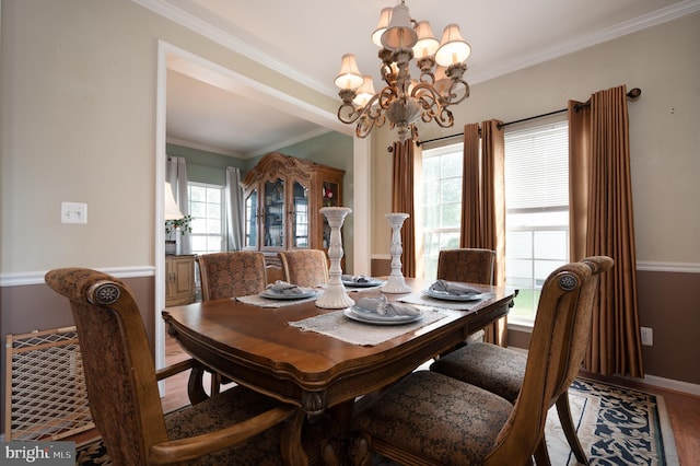 57 Pebble Creek Dr, Smyrna, DE 19977 - dining room with a chandelier, ornamental molding, wood finished floors, plenty of natural light, and baseboards