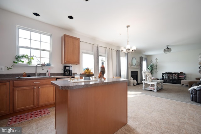 57 Pebble Creek Dr, Smyrna, DE 19977 - kitchen featuring a sink, a center island, dark countertops, and open floor plan