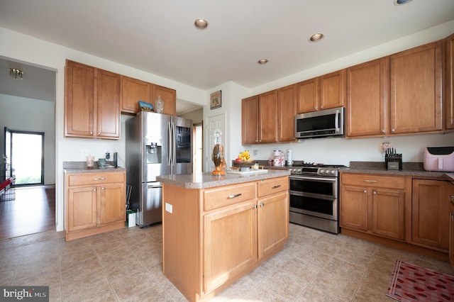 57 Pebble Creek Dr, Smyrna, DE 19977 - kitchen with stainless steel appliances, a center island, brown cabinets, and recessed lighting