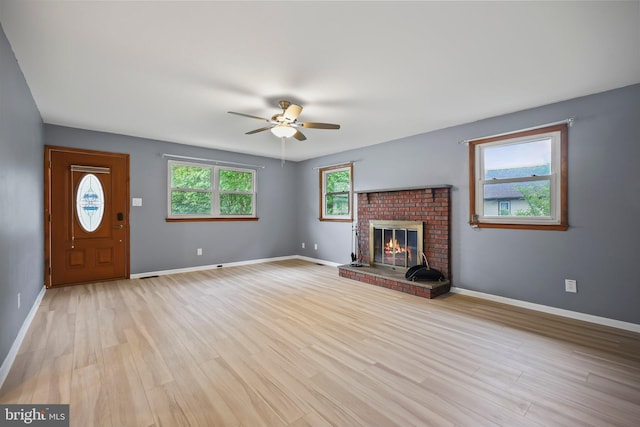 39 Riverview Ave, West Deptford, NJ 08086 - unfurnished living room with ceiling fan, light wood-style flooring, baseboards, and a brick fireplace