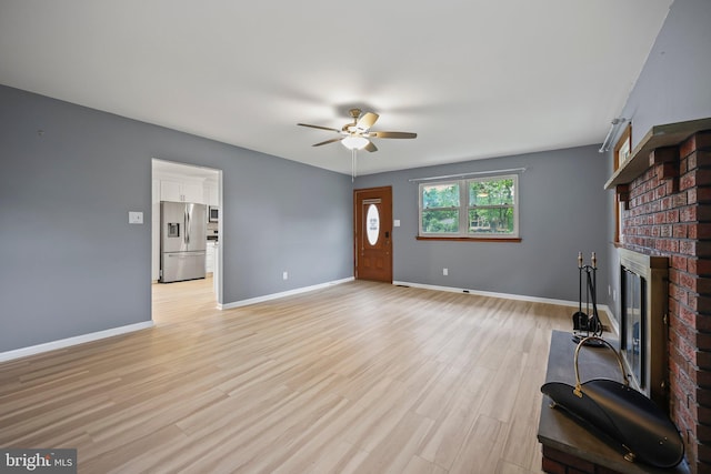 39 Riverview Ave, West Deptford, NJ 08086 - unfurnished living room featuring a ceiling fan, a fireplace, baseboards, and light wood-style floors