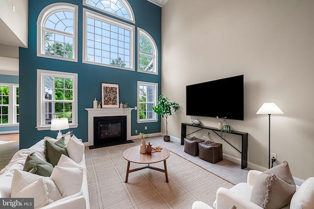 6354 Islington St, Middle River, MD 21220 - carpeted living area featuring a towering ceiling, baseboards, and a fireplace with flush hearth