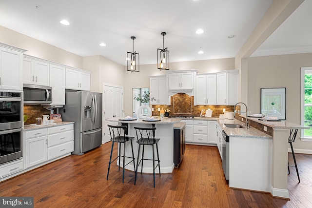 6354 Islington St, Middle River, MD 21220 - kitchen featuring a sink, appliances with stainless steel finishes, a kitchen bar, a peninsula, and recessed lighting