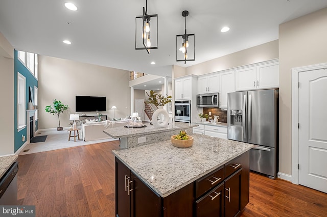 6354 Islington St, Middle River, MD 21220 - kitchen featuring appliances with stainless steel finishes, a fireplace, a kitchen island, light stone counters, and recessed lighting