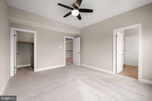 6354 Islington St, Middle River, MD 21220 - unfurnished bedroom with light carpet, baseboards, a walk in closet, a closet, and a ceiling fan