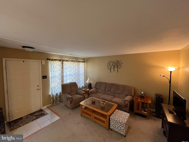 tiled living area featuring carpet flooring
