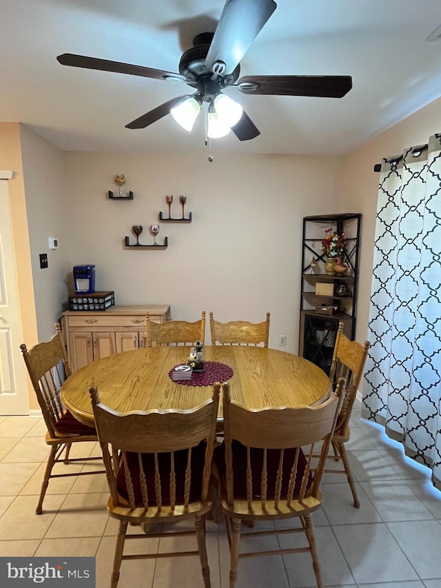 dining area with light tile patterned floors and a ceiling fan