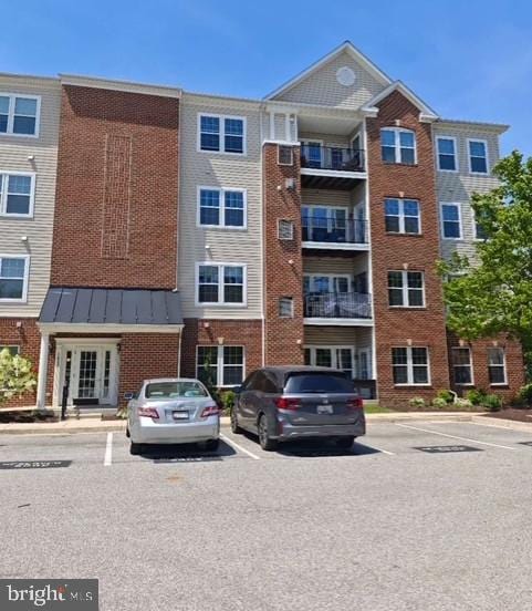 view of building exterior featuring uncovered parking