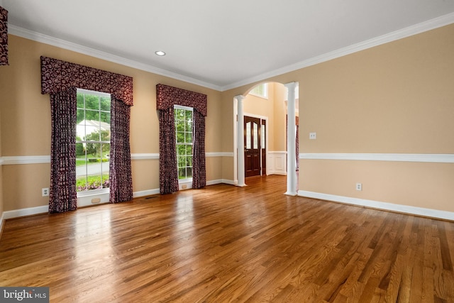 12850 Salmon Run Ct, Manassas, VA 20112 - empty room with wood finished floors, decorative columns, ornamental molding, arched walkways, and baseboards