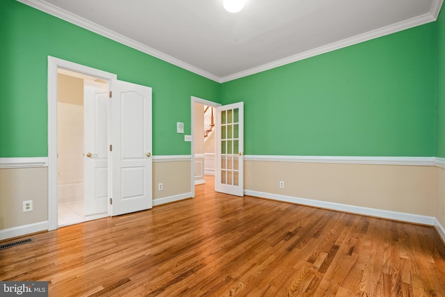 12850 Salmon Run Ct, Manassas, VA 20112 - unfurnished bedroom featuring baseboards, ornamental molding, visible vents, and wood finished floors