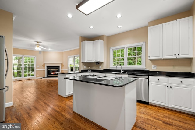 12850 Salmon Run Ct, Manassas, VA 20112 - kitchen featuring white cabinetry, dark countertops, stainless steel appliances, and open floor plan