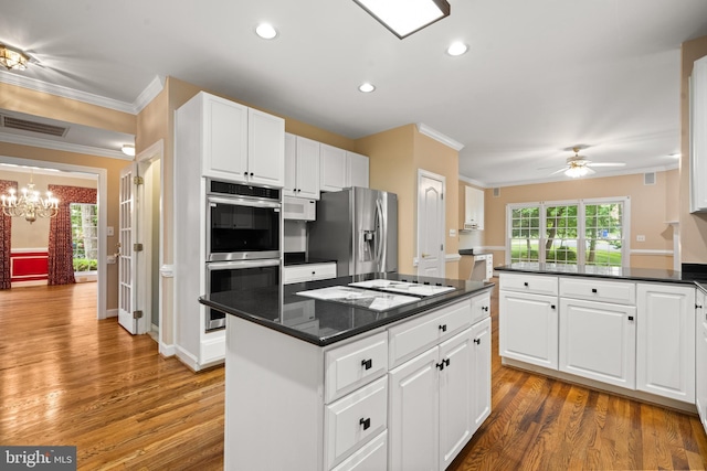 12850 Salmon Run Ct, Manassas, VA 20112 - kitchen featuring dark countertops, stainless steel appliances, light wood-style flooring, and a kitchen island