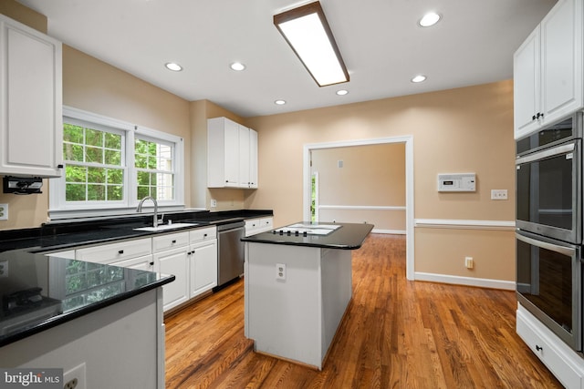 12850 Salmon Run Ct, Manassas, VA 20112 - kitchen featuring white cabinetry, stainless steel appliances, a sink, and wood finished floors