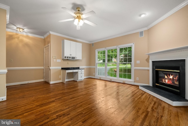12850 Salmon Run Ct, Manassas, VA 20112 - unfurnished living room featuring built in desk, wood finished floors, a ceiling fan, visible vents, and a glass covered fireplace