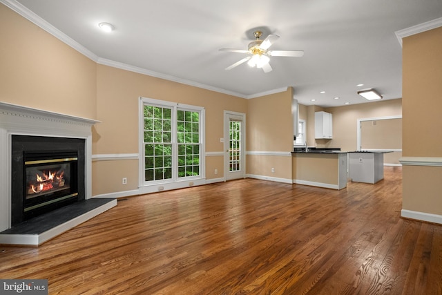 12850 Salmon Run Ct, Manassas, VA 20112 - unfurnished living room featuring wood finished floors, ornamental molding, ceiling fan, baseboards, and a glass covered fireplace