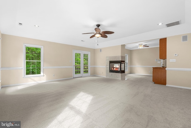 12850 Salmon Run Ct, Manassas, VA 20112 - unfurnished living room featuring a wealth of natural light, visible vents, a ceiling fan, and carpet floors