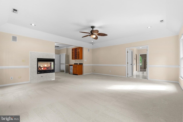 12850 Salmon Run Ct, Manassas, VA 20112 - unfurnished living room featuring a multi sided fireplace, visible vents, baseboards, ceiling fan, and light carpet