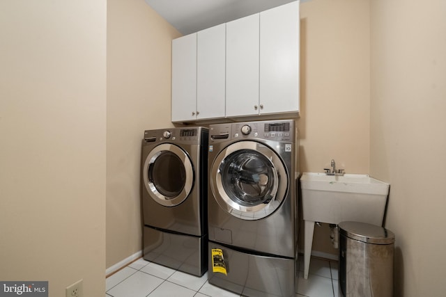 12850 Salmon Run Ct, Manassas, VA 20112 - laundry area featuring washing machine and clothes dryer, a sink, light tile patterned flooring, and cabinet space