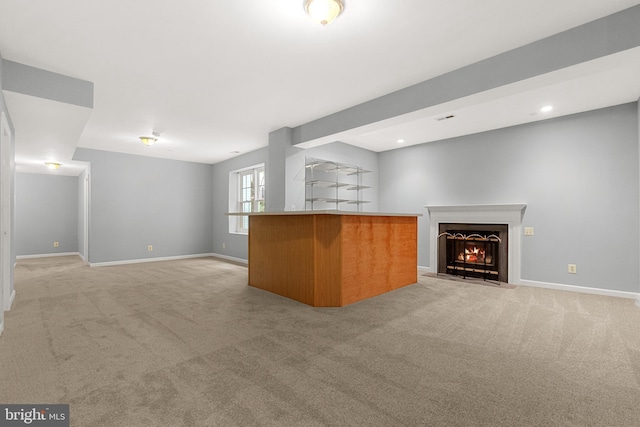 12850 Salmon Run Ct, Manassas, VA 20112 - unfurnished living room featuring light carpet, baseboards, and a fireplace with flush hearth