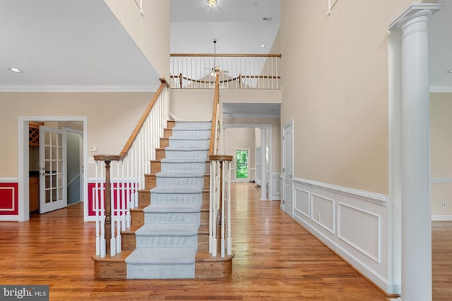12850 Salmon Run Ct, Manassas, VA 20112 - stairs featuring ornamental molding, a wainscoted wall, and wood finished floors