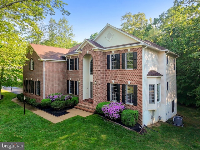 12850 Salmon Run Ct, Manassas, VA 20112 - view of front of property featuring central air condition unit, brick siding, and a front yard