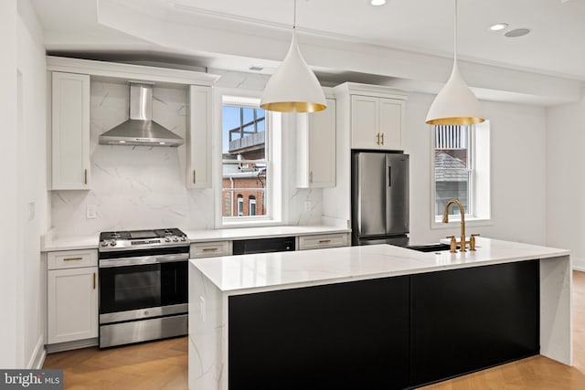 kitchen featuring a sink, wall chimney exhaust hood, stainless steel appliances, decorative backsplash, and ornamental molding