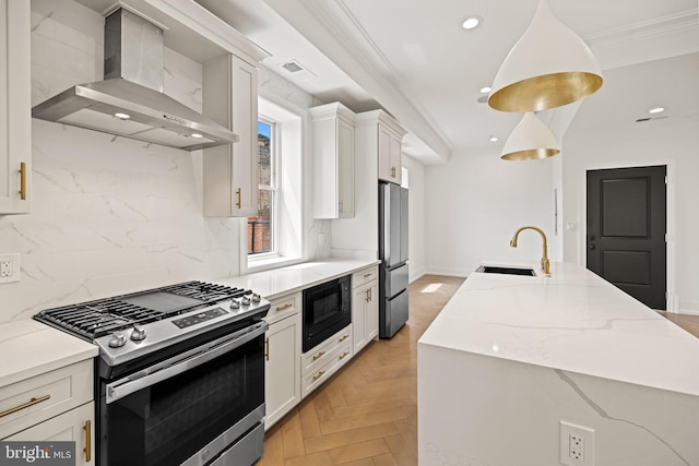 kitchen with wall chimney range hood, backsplash, a center island with sink, a sink, and stainless steel appliances