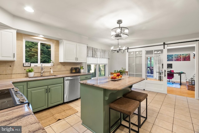 kitchen with stainless steel dishwasher, an inviting chandelier, light tile patterned floors, and green cabinets