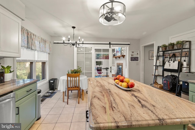 dining area featuring light tile patterned flooring and a notable chandelier