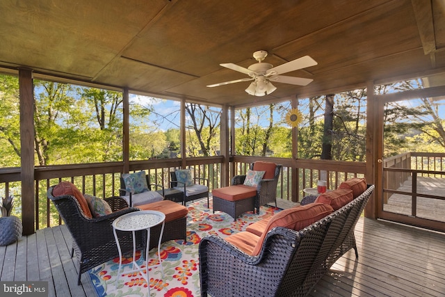 sunroom / solarium featuring plenty of natural light, outdoor lounge area, and a ceiling fan