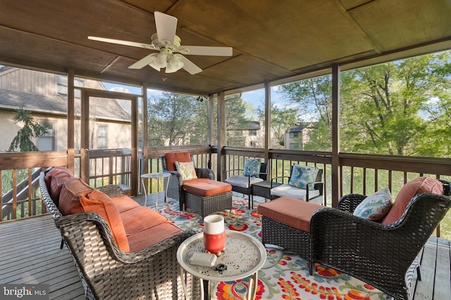 sunroom featuring ceiling fan and outdoor lounge area