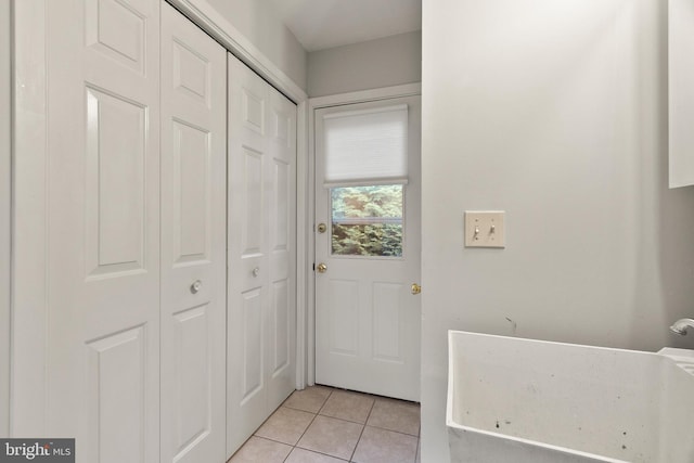 doorway with light tile patterned floors
