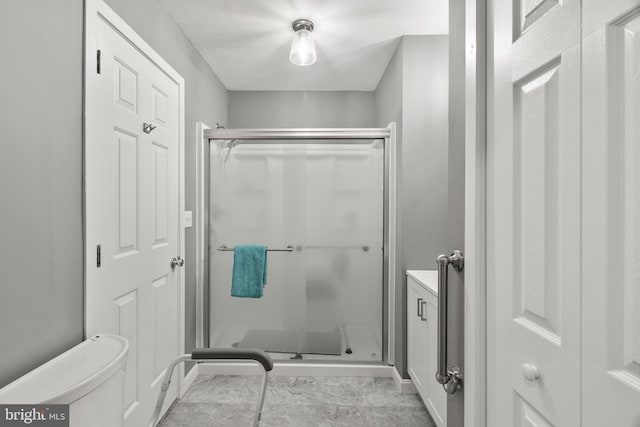 full bath featuring vanity, a stall shower, and toilet
