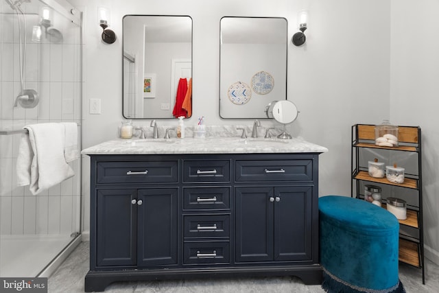 bathroom with a sink, a stall shower, and double vanity