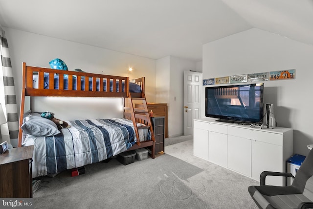 bedroom with carpet and vaulted ceiling
