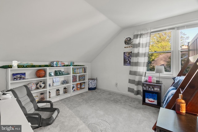 living area with baseboards, carpet flooring, and vaulted ceiling