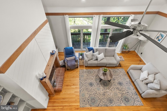 living room featuring a ceiling fan and wood finished floors