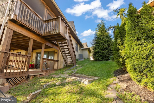 view of yard with a wooden deck, cooling unit, and stairway
