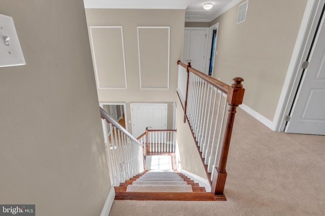 stairway featuring visible vents, ornamental molding, baseboards, and carpet floors