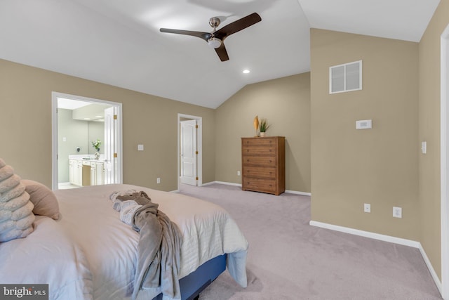 bedroom with visible vents, lofted ceiling, light carpet, baseboards, and connected bathroom