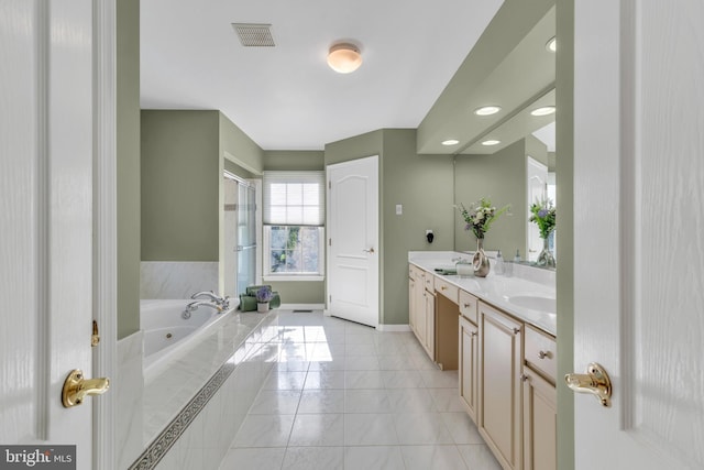 bathroom featuring visible vents, double vanity, a jetted tub, a shower stall, and a sink